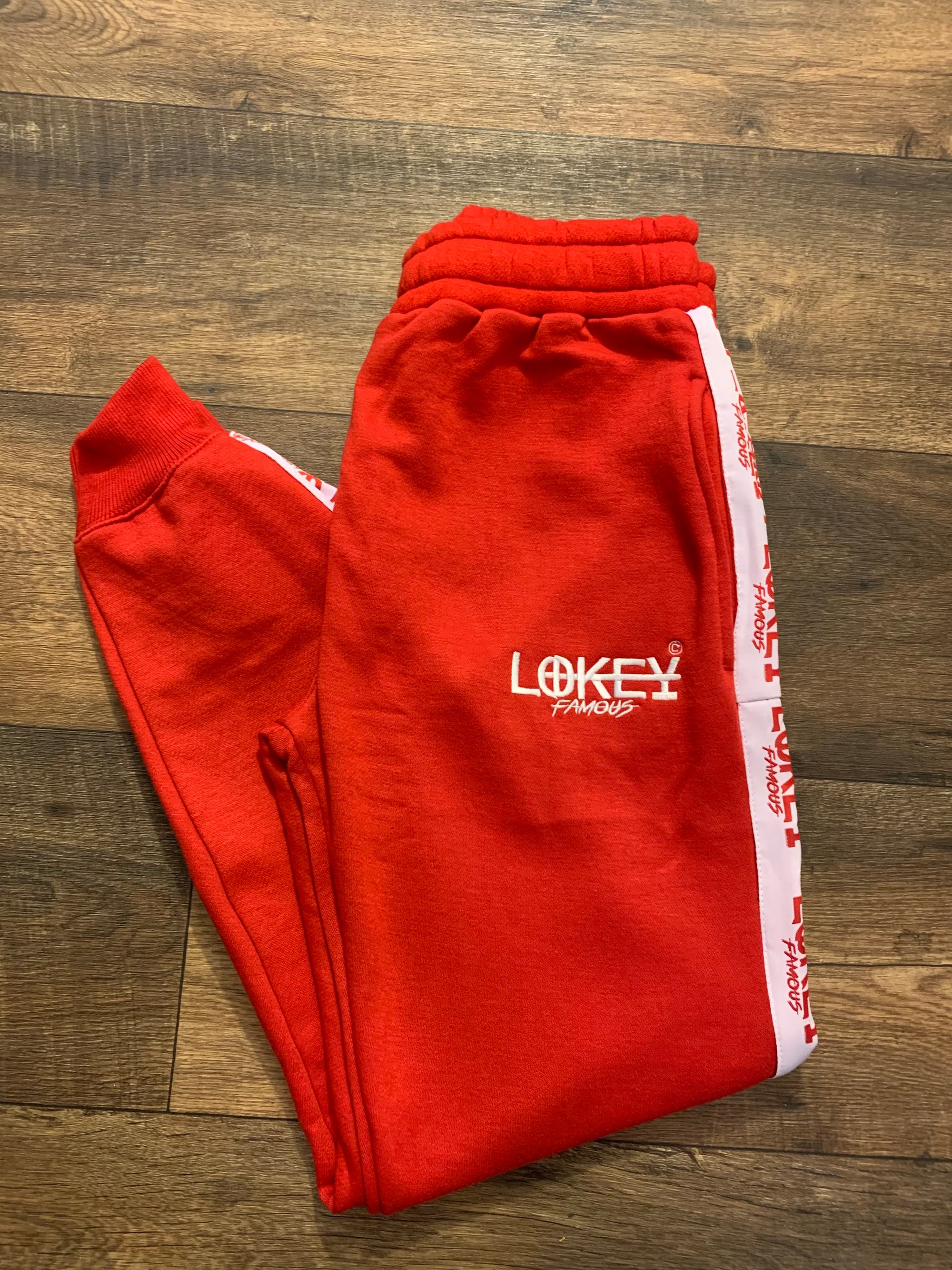 Red sweatpants with white stripe