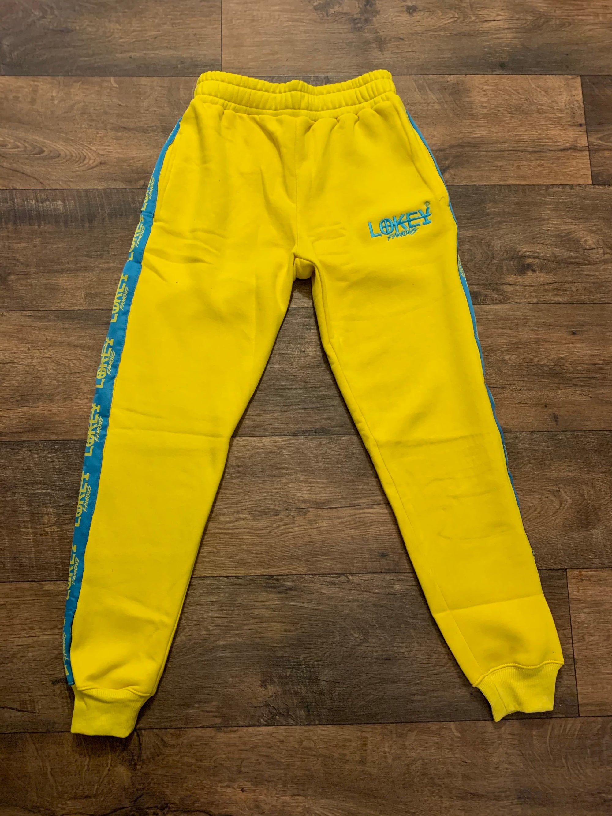 Yellow sweatpants with teal stripe