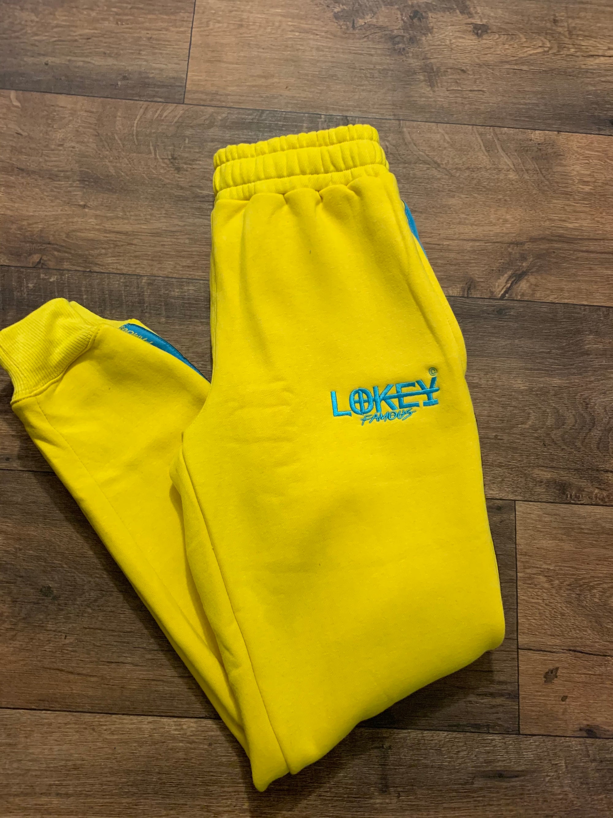 Yellow sweatpants with teal stripe