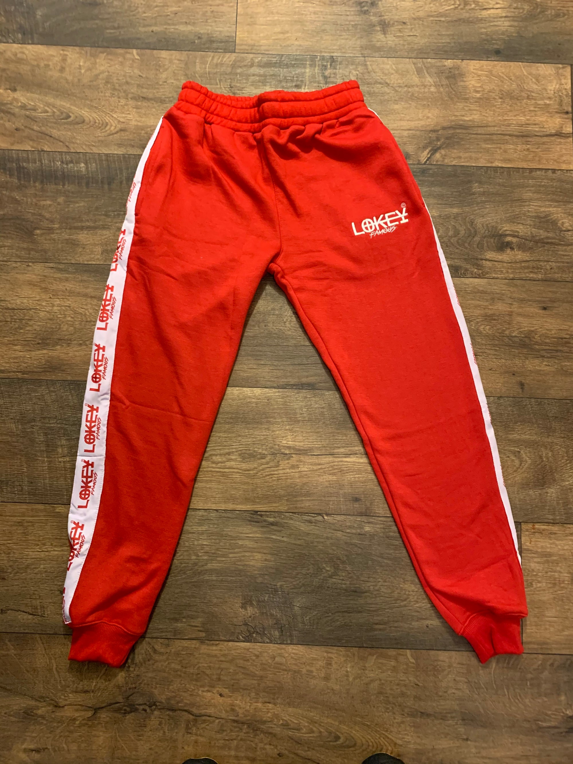 Red sweatpants with white stripe